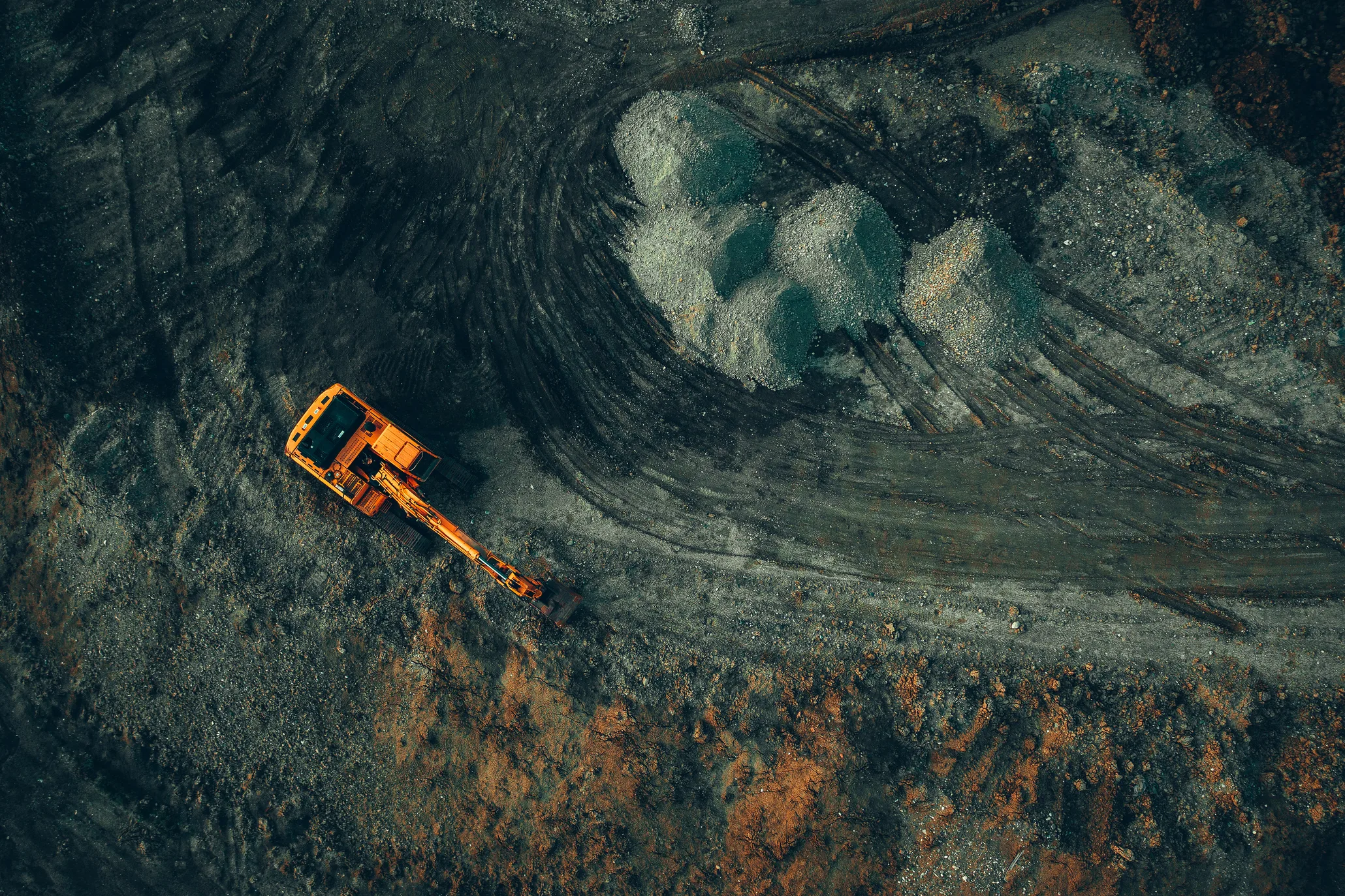 Bright Excavator At Work On A Dark Background View From A Drone